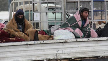 Syrians being evacuated from Aleppo are seen in the back of a pick up truck as it drives through a rebel-held territory near Rashidin on December 22, 2016. (File photo: AFP)
