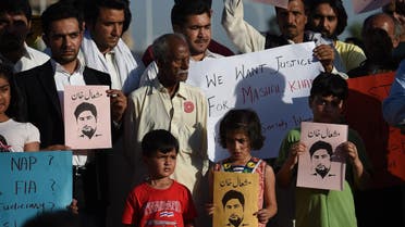 Pakistani civil society members, university students and children hold placards as they take part in a protest against the killing of Mashal Khan, a journalism student, in Islamabad on April 15, 2017. (AFP)