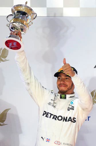 Mercedes driver Lewis Hamilton of Britain lifts his trophy on the podium after the Bahrain Formula One Grand Prix, at the Formula One Bahrain International Circuit in Sakhir, Bahrain, Sunday, April 16, 2017. Hamilton finished second. (AP PhotoHassan Ammar)