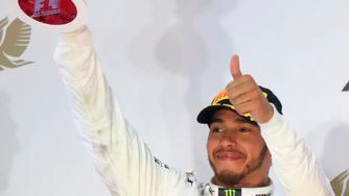 Mercedes driver Lewis Hamilton of Britain lifts his trophy on the podium after the Bahrain Formula One Grand Prix, at the Formula One Bahrain International Circuit in Sakhir, Bahrain, Sunday, April 16, 2017. Hamilton finished second. (AP PhotoHassan Ammar)