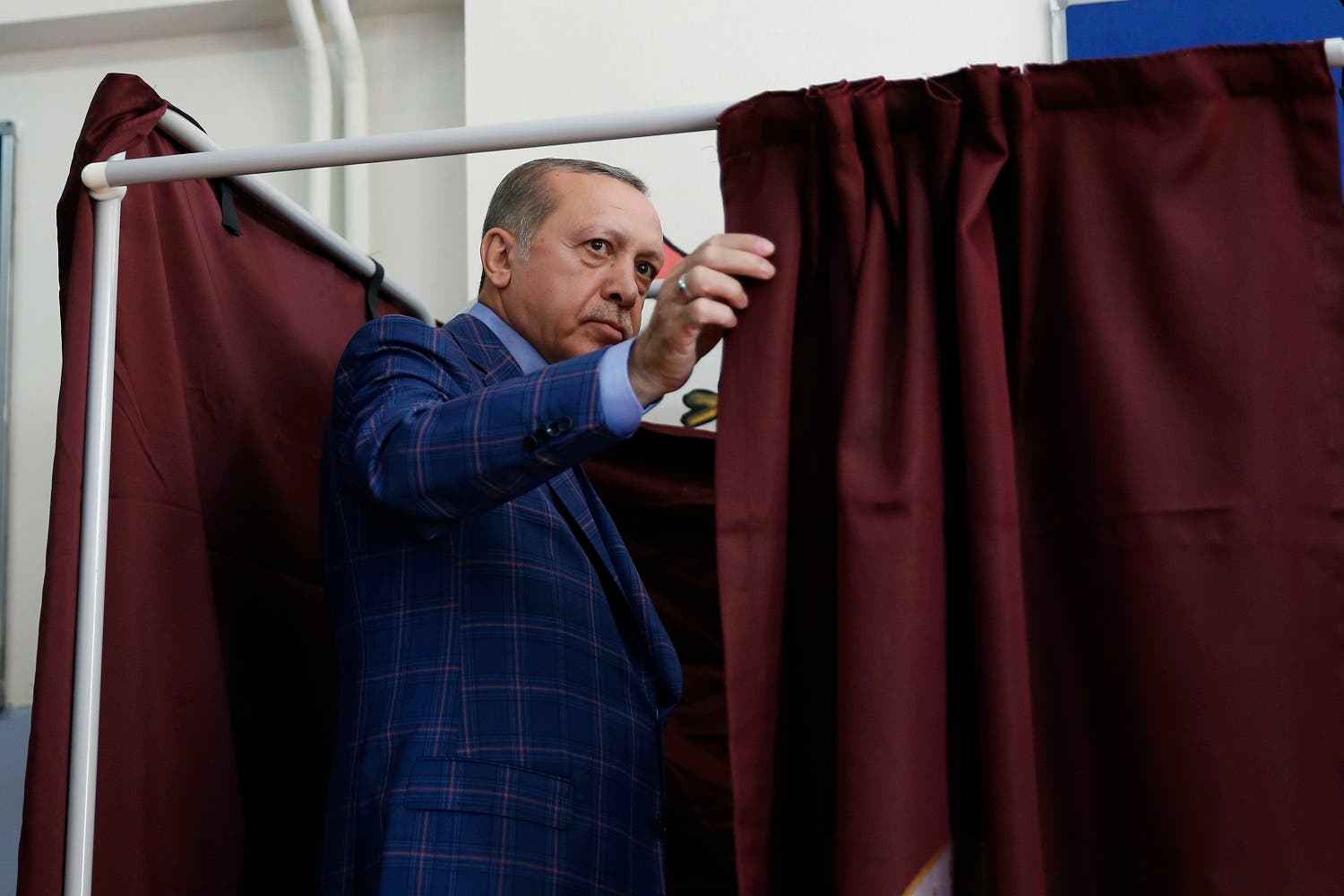 Turkey’s President Recep Tayyip Erdogan enters a voting booth inside a polling station in Istanbul, Turkey, on Sunday, April 16, 2017 (Photo: AP/Lefteris Pitarakis)