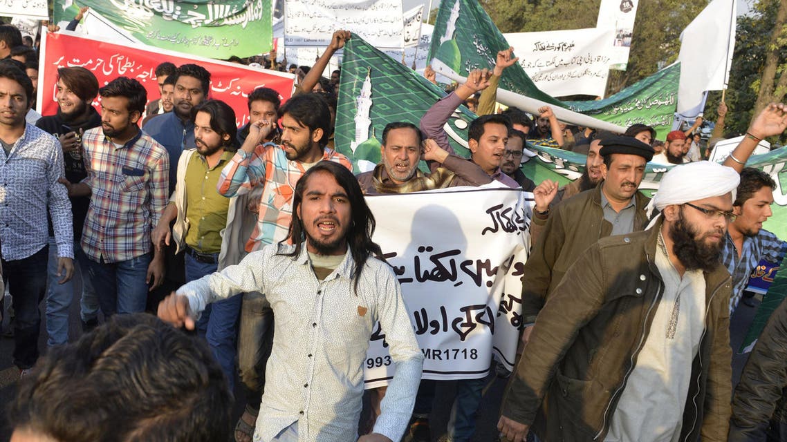 Pakistanis protest against the arrest of a shopkeeper charged with blasphemy after he banned members of the Ahmadi minority from entering his shop. ap