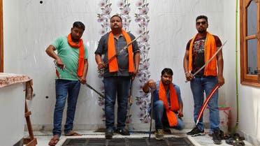 Hindu Yuva Vahini members pose inside the vigilante group's office in the city of Unnao, India, April 5, 2017. Picture taken April 5, 2017. REUTERS