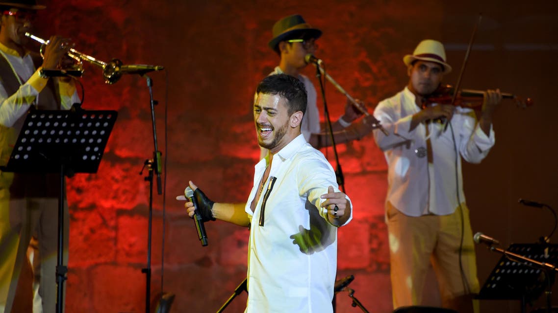 Morocco singer Saad Lamjarred performs with Ukrainian Orchestra Symphonic at the opening of the Carthage Festival on July 30, 2016 at the romain theatre of carthage near Tunis. FETHI BELAID / AFP