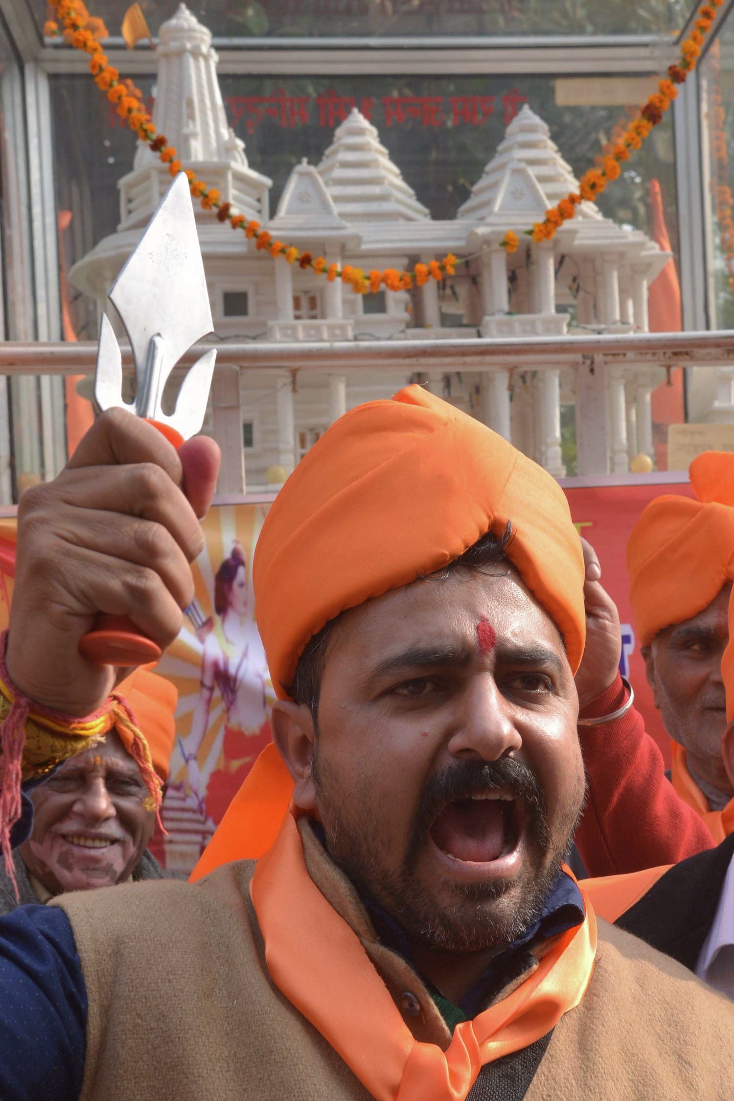Indian activists of Hindu Bajrang Dal, along with Vishva Hindu Parishad (VHP) organizations, raise religious slogans during a procession marking the 23rd anniversary of the demolition of the Babri Masjid Mosque in Ayodhya, in Amritsar on December 6, 2015. (AFP)