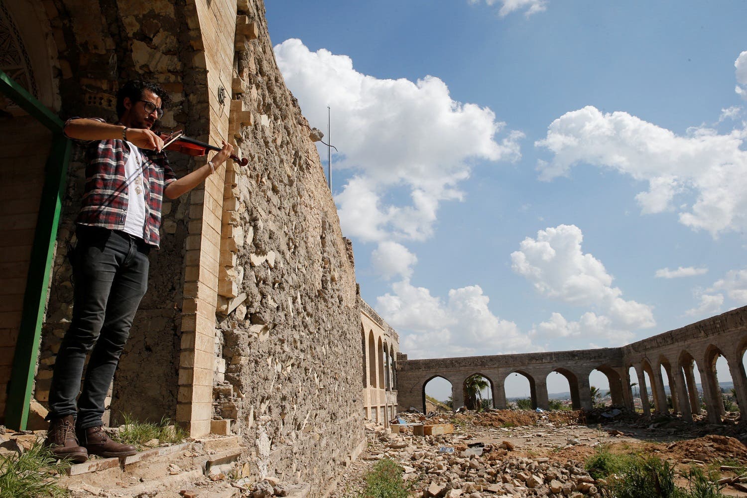 Ameen Mukdad plays the violin in Mosul, at the ISIS-destroyed shrine of the Prophet Jonah, a religious figure in Judaism, Christianity, and Islam. (Reuters)