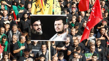 Lebanese Hezbollah supporters carry flags and a picture of Lebanon's Hezbollah leader Sayyed Hassan Nasrallah and leader of Yemen's Houthi movement Abdel Malek al-Houthi at a religious procession to mark Ashura in Beirut's southern suburbs, Lebanon October 12, 2016. (Reuters)