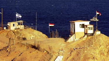 ** FILE ** Israeli, left, and Egyptian flags flutter in the wind at the border post between the two countries in this Sunday, Jan. 21, 2001 file photo taken out of the window of the Hilton hotel in the Red Sea resort of Taba, Egypt, approximately 100 meters from the crossing. (AP Photo/Enric Marti)