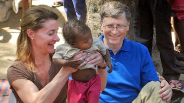 File photo of Microsoft Corp. founder and philanthropist Bill Gates, right, and his wife Melinda Gates attend to a child as they meet with members of the Mushar community at Jamsot Village near Patna, India. (AP)