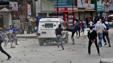 Kashmiri students and other protesters throw stones at an Indian police vehicle as they clash with police in Srinagar, Indian controlled Kashmir, Monday, April 24, 2017. (AP)