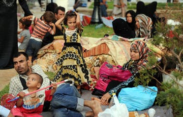Syrian nationals fleeing the conflict in their home country gather in a garden in Port Said Square in Algiers on July 28, 2012. (File photo: AFP)