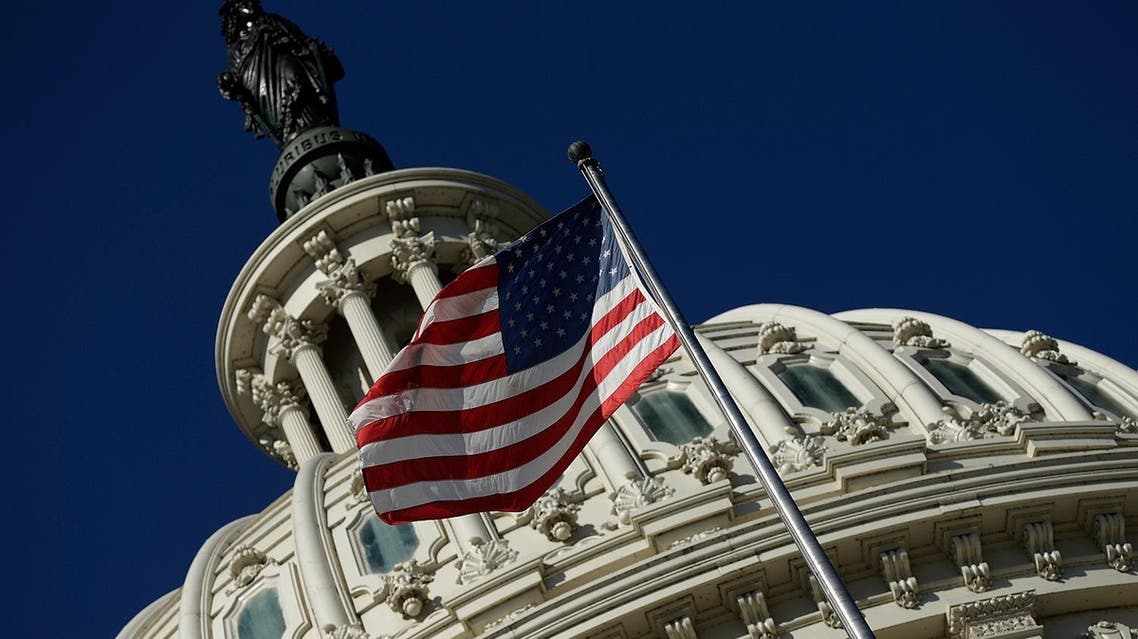 An American flag waves outside the US Capitol building as Congress remains gridlocked over legislation to continue funding the federal government September 29, 2013 in Washington, DC. (AFP)
