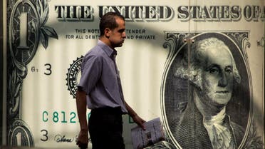 An Egyptian man walks past a poster showing a U.S. dollar outside an exchange office in Cairo, Egypt, Thursday, Nov. 3, 2016. (Reuters)