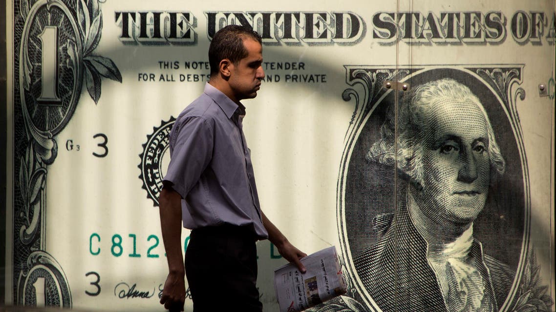 An Egyptian man walks past a poster showing a U.S. dollar outside an exchange office in Cairo, Egypt, Thursday, Nov. 3, 2016. (Reuters)