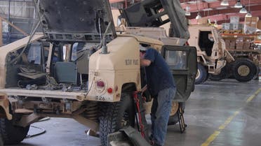 A civilian contractor works on armored vehicles at Camp Arifjan US Military base, 60 km South of Kuwait City (File Photo: AP/Gustavo Ferrari)