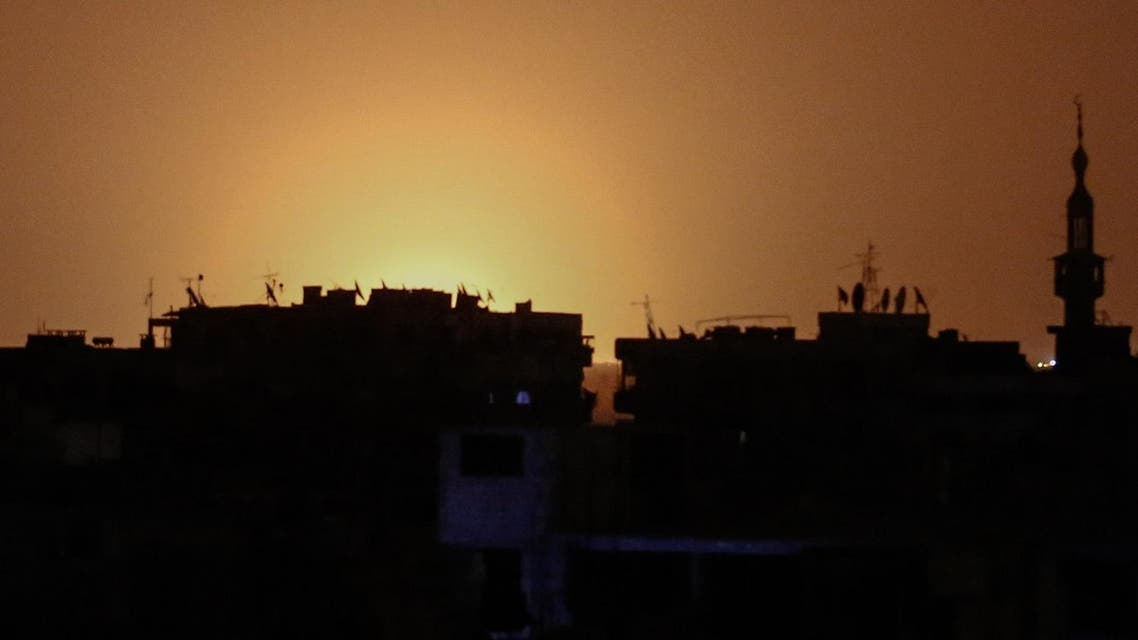 A photo taken from the rebel-held town of Douma shows flames rising in the distance which are believed to be coming from Damascus International Airport following an explosion early in the morning of April 27, 2017. (AFP)