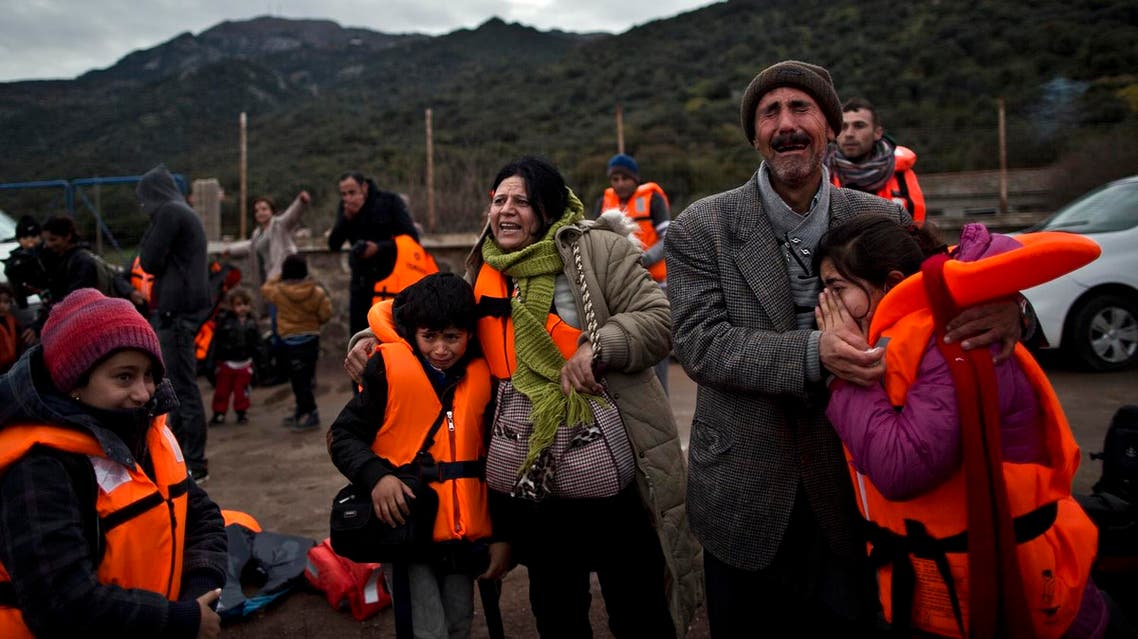 In this Thursday, Dec. 3, 2015 photo, Yazidi refugee Samir Qasu, 45, right, from Sinjar, Iraq, and his wife Bessi, 42, cry while embracing their children, Dunia, 13, and Dildar, 10, shortly after arriving on a vessel from the Turkish coast to the northeastern Greek island of Lesbos. (AP)