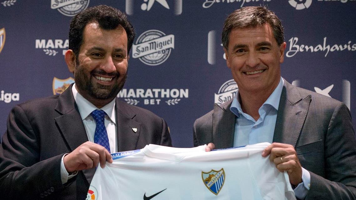 Malaga's new coach Jose Miguel Gonzalez Martin del Campo aka Michel (R) poses with Malaga CF's chairman Sheikh Abdallah Ben Nasser Al-Thani during his official presentation at the Rosaleda stadium in Malaga, on March 8, 2017. (AFP)
