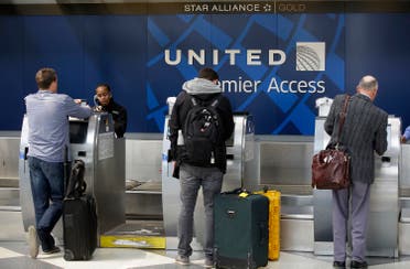 Travelers check-in at the United Airlines Premier Access at O'Hare International Airport on April 12, 2017 in Chicago, Illinois. (AFP)