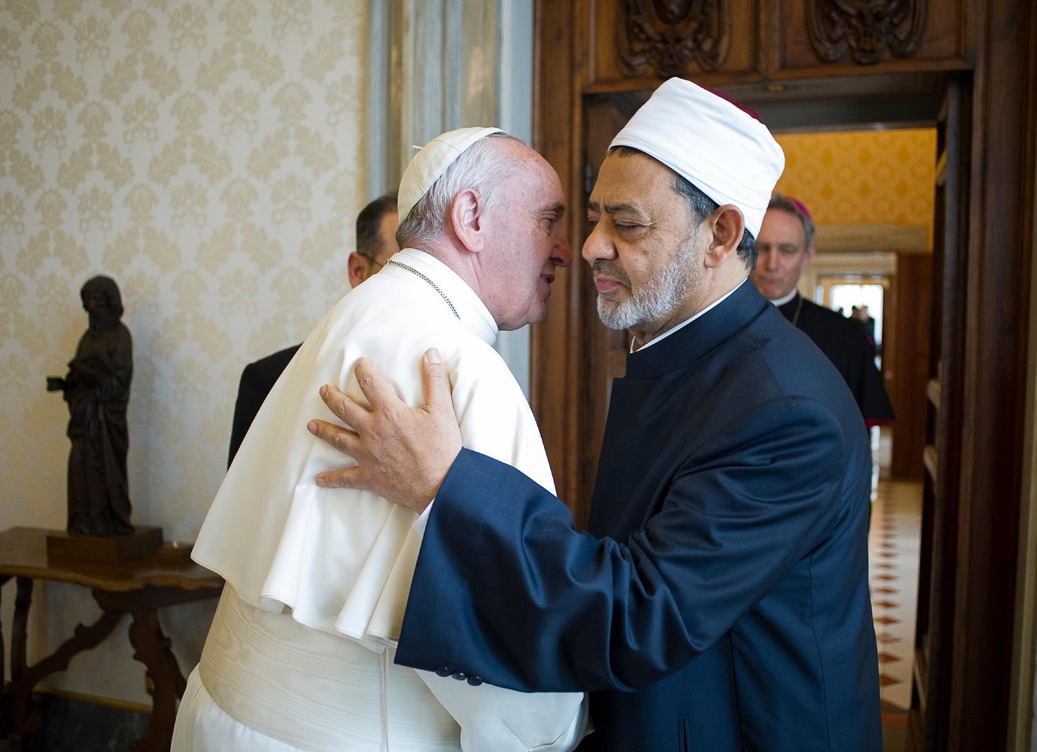 This file handout photo released by the Vatican press office on May 23, 2016 shows Pope Francis (L) embracing Egyptian Grand Imam of al-Azhar Mosque Sheikh Ahmed Mohamed al-Tayeb (R), during a private audience at the Vatican.