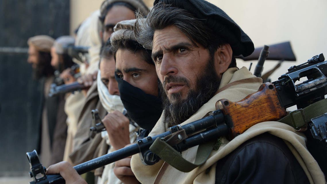 Afghan alleged former Taliban fighters carry their weapons before handing them over as part of a government peace and reconciliation process at a ceremony in Jalalabad on February 24, 2016. (AFP)