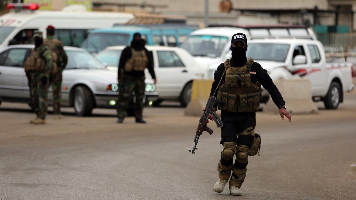 Iraqi policemen guard the area as Sunni and Shiite tribal clerics and leaders meet to dicuss reconciliation between the Muslim sects and recent sectarian violence in the town of Muqdadiyah, northeast of Baghdad, in Iraq's mix province of Diyala, on January 23, 2016.