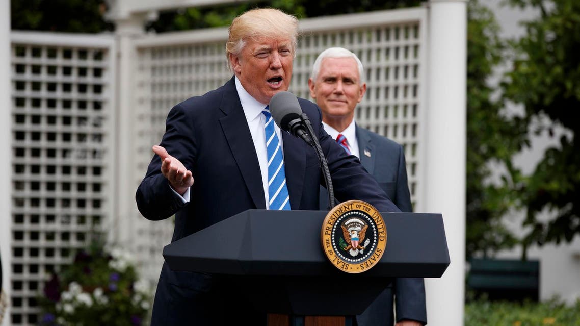 President Donald Trump, accompanied by Vice President Mike Pence, speaks to the Independent Community Bankers Association, Monday, May 1, 2017, in the Kennedy Garden of the White House in Washington. (AP Photo/Evan Vucci)