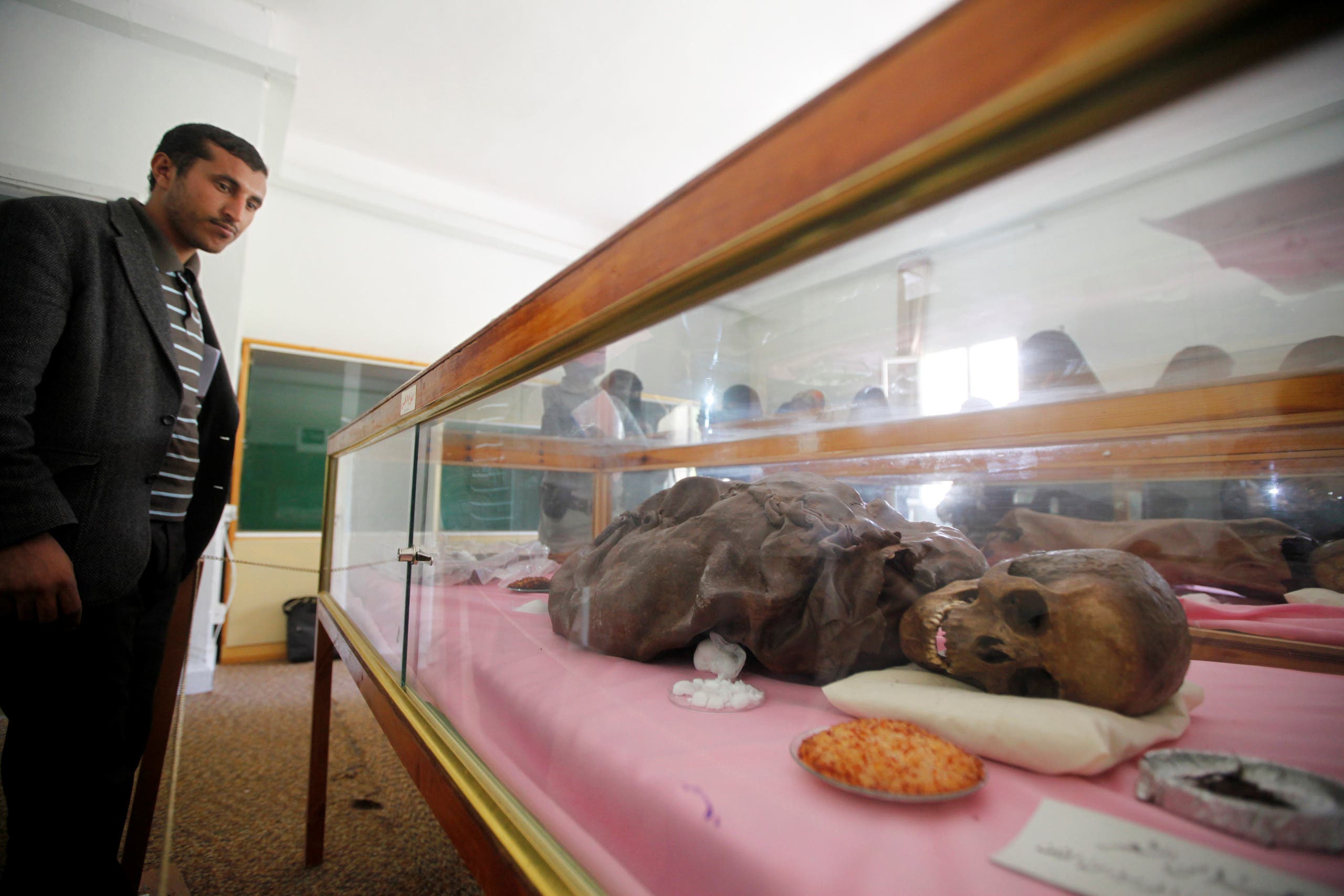 A man looks at a mummy dating back to an ancient Yemen era displayed at a museum at Sanaa University, in Sanaa, Yemen April 29, 2017. reuters