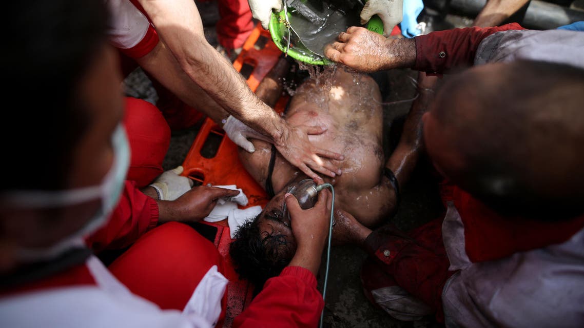 Rescue workers try to resuscitate a coal miner after he was pulled out from a mine in Azadshahr, in northern Iran, following an explosion leaving dozens of miners trapped on May 3, 2017. The mine in Golestan province collapsed when trapped methane gas exploded as workers tried to jump-start a locomotive engine, according to reports.