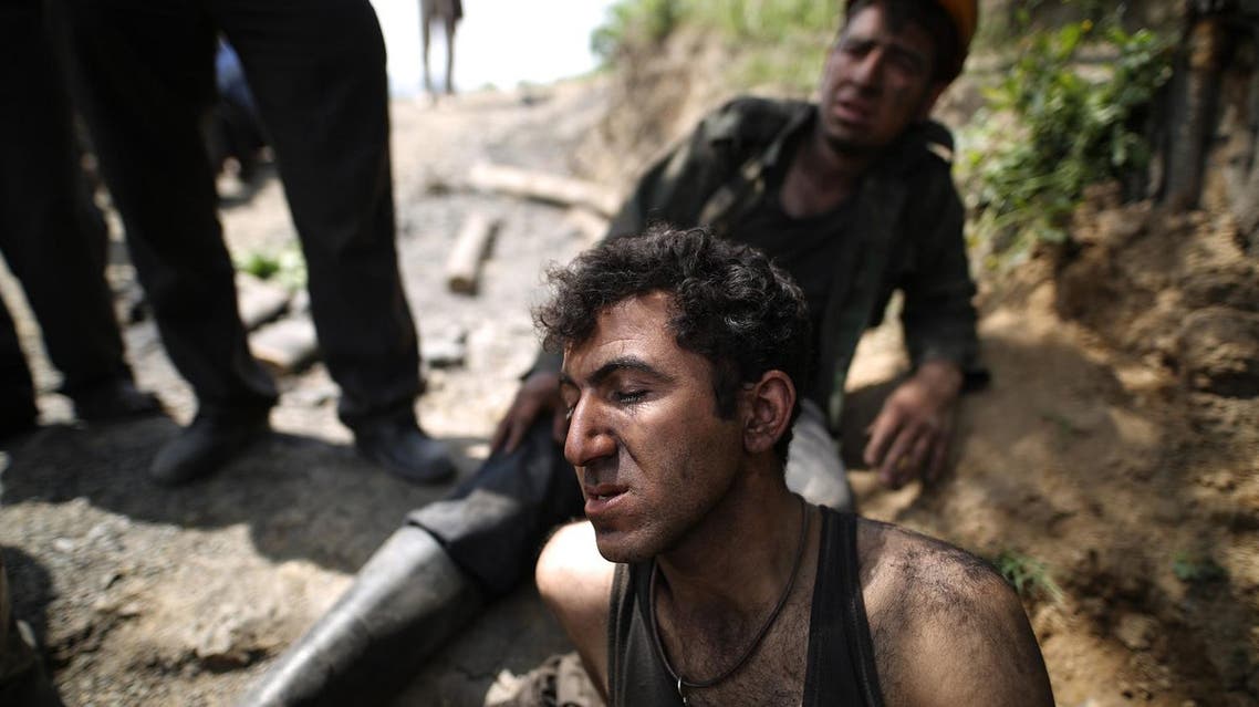 Coal miners react following an explosion in a mine in Azadshahr, in northern Iran, leaving dozens of miners trapped on May 3, 2017. (AFP)