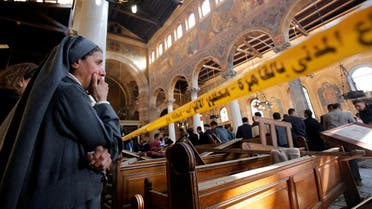 A nun cries as she stands at the scene inside Cairo's Coptic cathedral, following a bombing, in Egypt. (Reuters)
