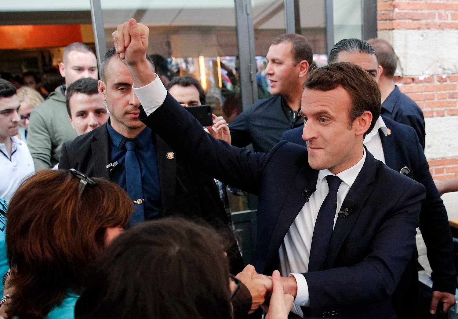 French independent centrist presidential candidate Emmanuel Macron, right, shakes hands with supporters during a campaign rally in Albi, southern France, Thursday, May 4, 2017. (AP)