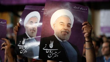 Supporters of Iranian presidential candidate Hassan Rouhani hold his portrait during a campaign rally in the capital Tehran on May 4, 2017. (AFP)