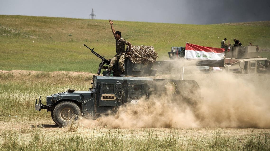 A member of the Iraqi forces' Emergency Response Division (ERD) rides on top of a humvee advancing on the frontlines in west Mosul on May 6, 2017, during the offensive to retake the area from Islamic State (IS) group fighters. (AFP)