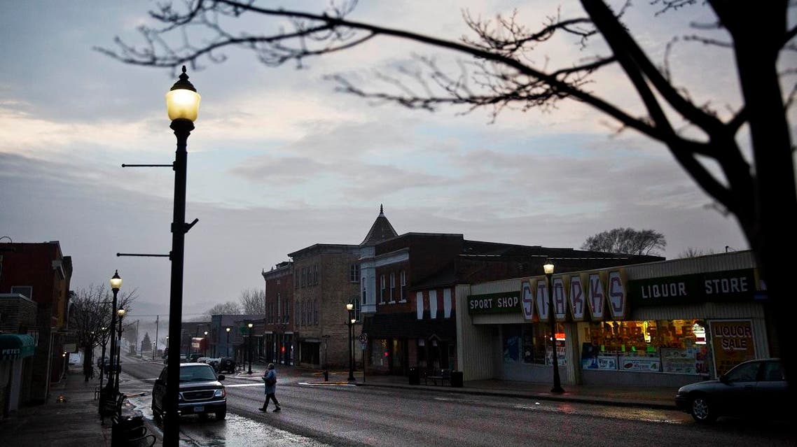 A customer crosses the street while leaving a shop along the main business district in Prairie du Chien, Wis., in Crawford County, Thursday, Jan. 19, 2017. (AP)