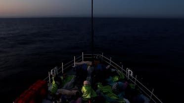 Migrants rest on the Malta-based NGO Migrant Offshore Aid Station (MOAS) ship Phoenix after being rescued in the central Mediterranean off the Libyan coast, as the ship makes its way towards Italy at dusk, April 17, 2017. REUTERS