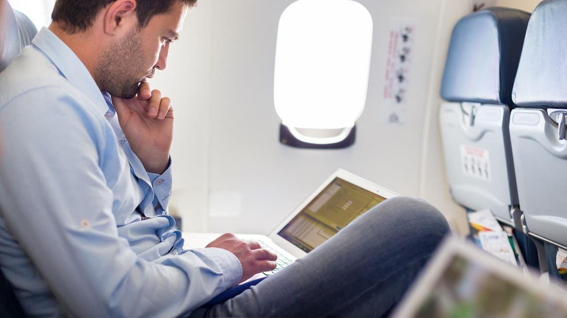 Laptop usage on airplane. (Shutterstock)