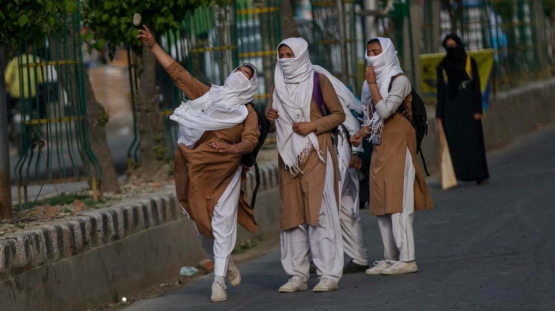 A Kashmiri schoolgirl throws stones at Indian paramilitary soldiers during a protest in Srinagar on April 20, 2017. (AP)