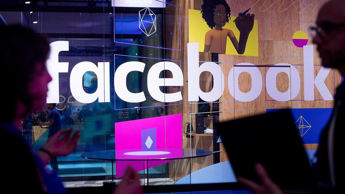In this April 18, 2017 file photo, conference workers speak in front of a demo booth at Facebook's annual F8 developer conference in San Jose, California. (AP)