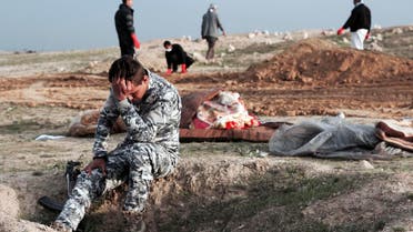 An Iraqi policeman at the burial site for bodies found in a mass grave in an area recently re-taken from ISIS in Hamam al-Alil, Iraq on March 15, 2017. (File photo: AP)