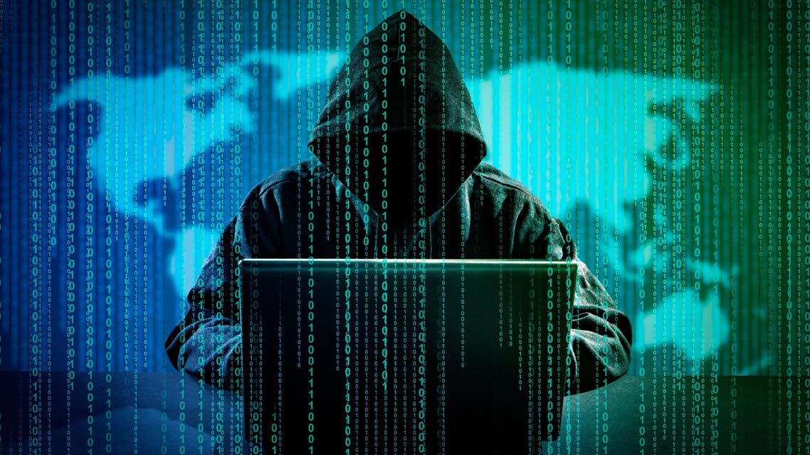 Hacker with laptop initiating cyber attack test