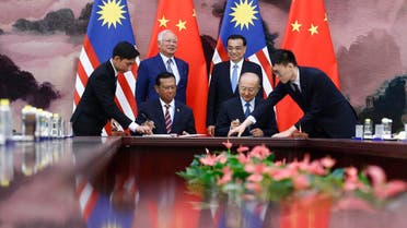 Chinese Premier Li Keqiang (back right), and Malaysian Prime Minister Najib Razak, (back left), attend a signing ceremony at the Great Hall of the People in Beijing on May 13, 2017. (AP)
