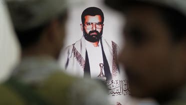 A photo of the movement's founder Hussein Badruddin al-Houthi is pictured between followers of the Houthi movement attending a vigil marking the anniversary of his killing, in Sanaa, Yemen April 23, 2017. (Reuters)