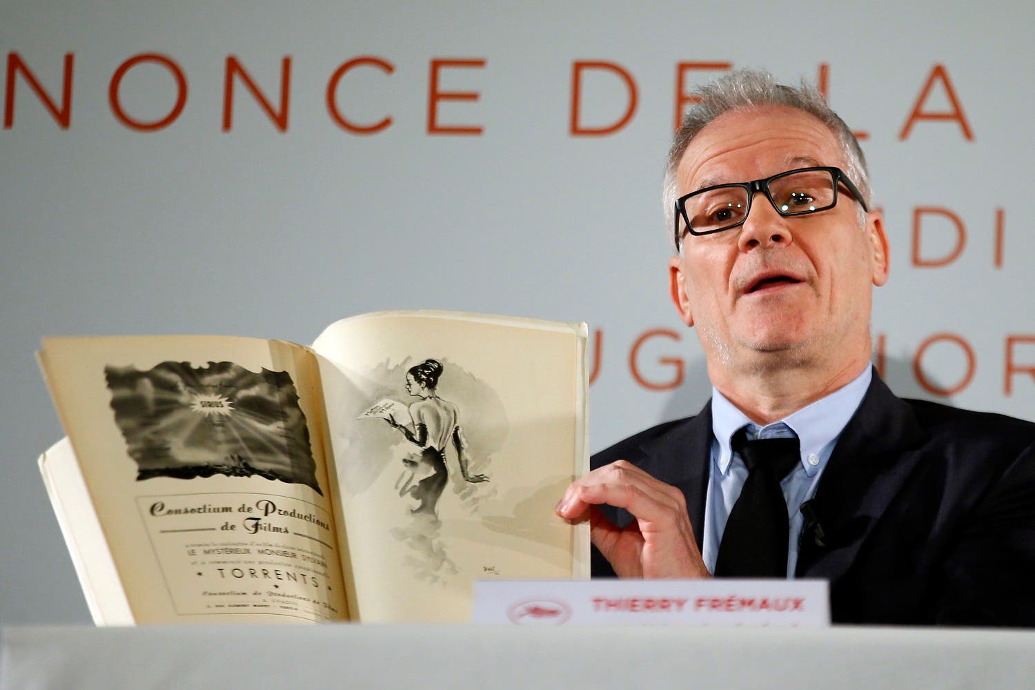 Cannes director Thierry Fremaux displays a 1946th festival book during a press conference for the 70th edition of the festival. (AP)