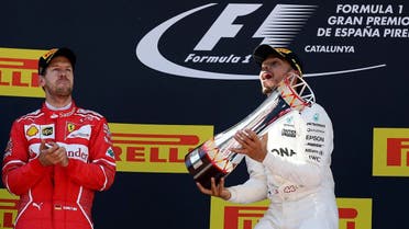 Mercedes driver Lewis Hamilton  (right), and Ferrari's  Sebastian Vettel of Germany celebrate after placing first and second at the Spanish Formula One GP. (AP)