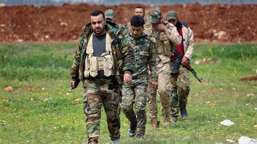 Members of the Syrian government forces march near the town of Qumhanah in the countryside of the central province of Hama, on April 1, 2017. Syrian government forces and allies regained most of the territory they lost earlier during an assault by rebels and jihadists launched on March 21, 2017 in the country's centre, reported the Britain-based Syrian Observatory for Human Rights monitor on March 31, 2017. (AFP)