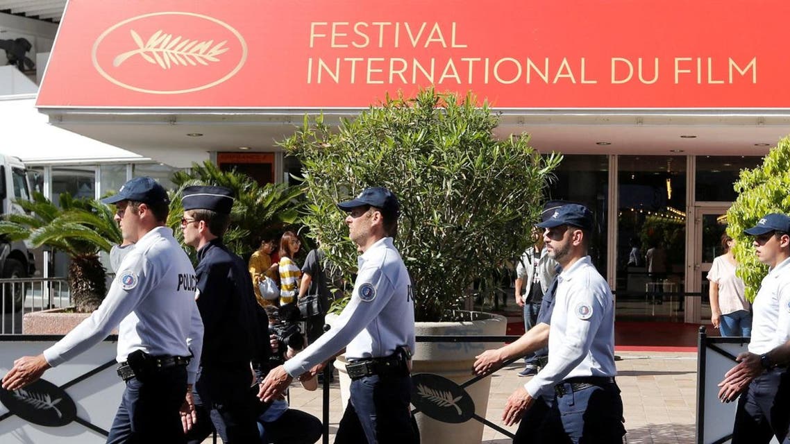 French policemen walk past the festival palace. (Reuters)