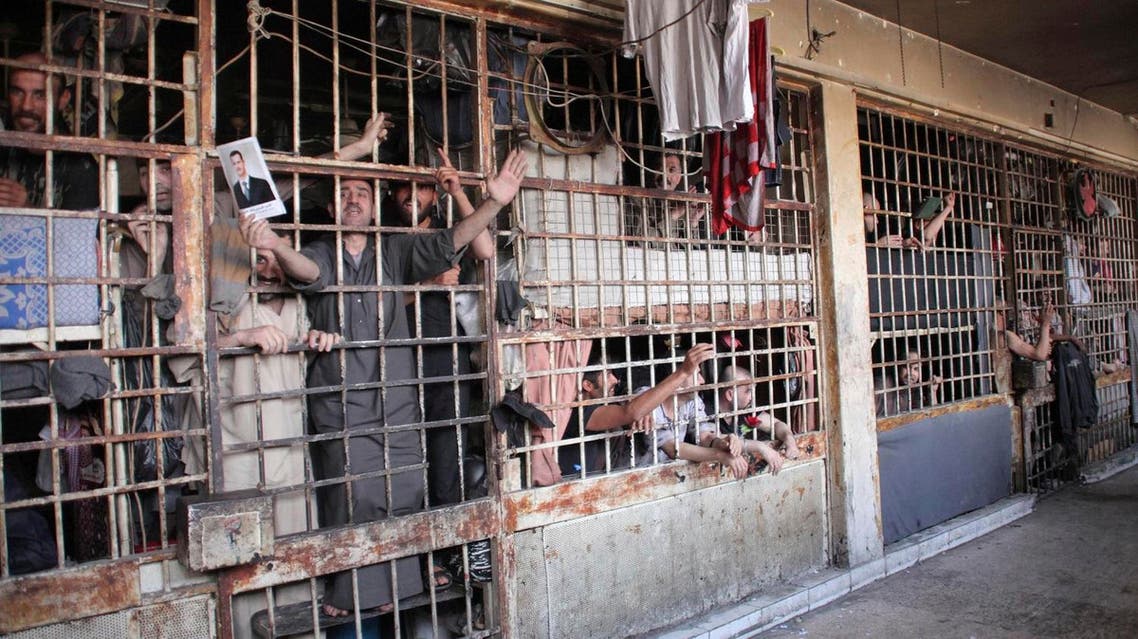 Inmates are seen behind bars in Aleppo's main prison May 22, 2014. (Reuters)