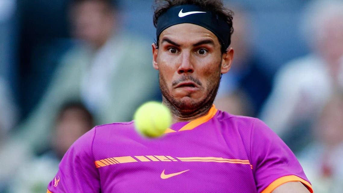 Spanish tennis player Rafael Nadal returns the ball to Austrian tennis player Dominic Thiem during their ATP Madrid Open final match in Madrid, on May 14, 2017. Nadal won 7-6 and 6-4. (