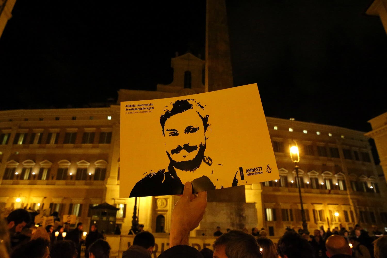 DATE IMPORTED: January 25, 2017 A man holds a placard during a vigil to commemorate Giulio Regeni, who was found murdered in Cairo a year ago, in downtown Rome, Italy January 25, 2017. (Reuters)